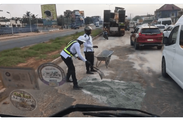 Netizens React as Ghana Police Officers Seen Fixing Potholes on Highway